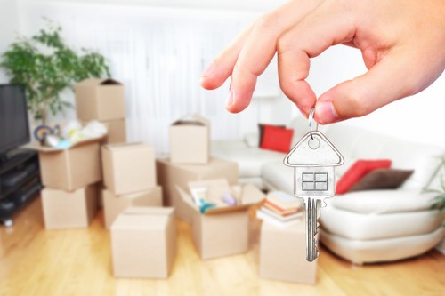 Local movers handling furniture in a Watford flat move