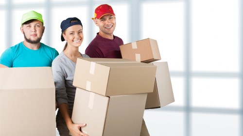 Local moving team loading furniture into a van in Watford