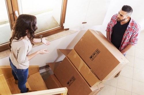 Moving boxes and furniture in a Watford residential property